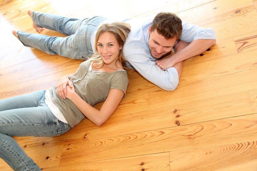 Couple relaxing on a finished hardwood floor